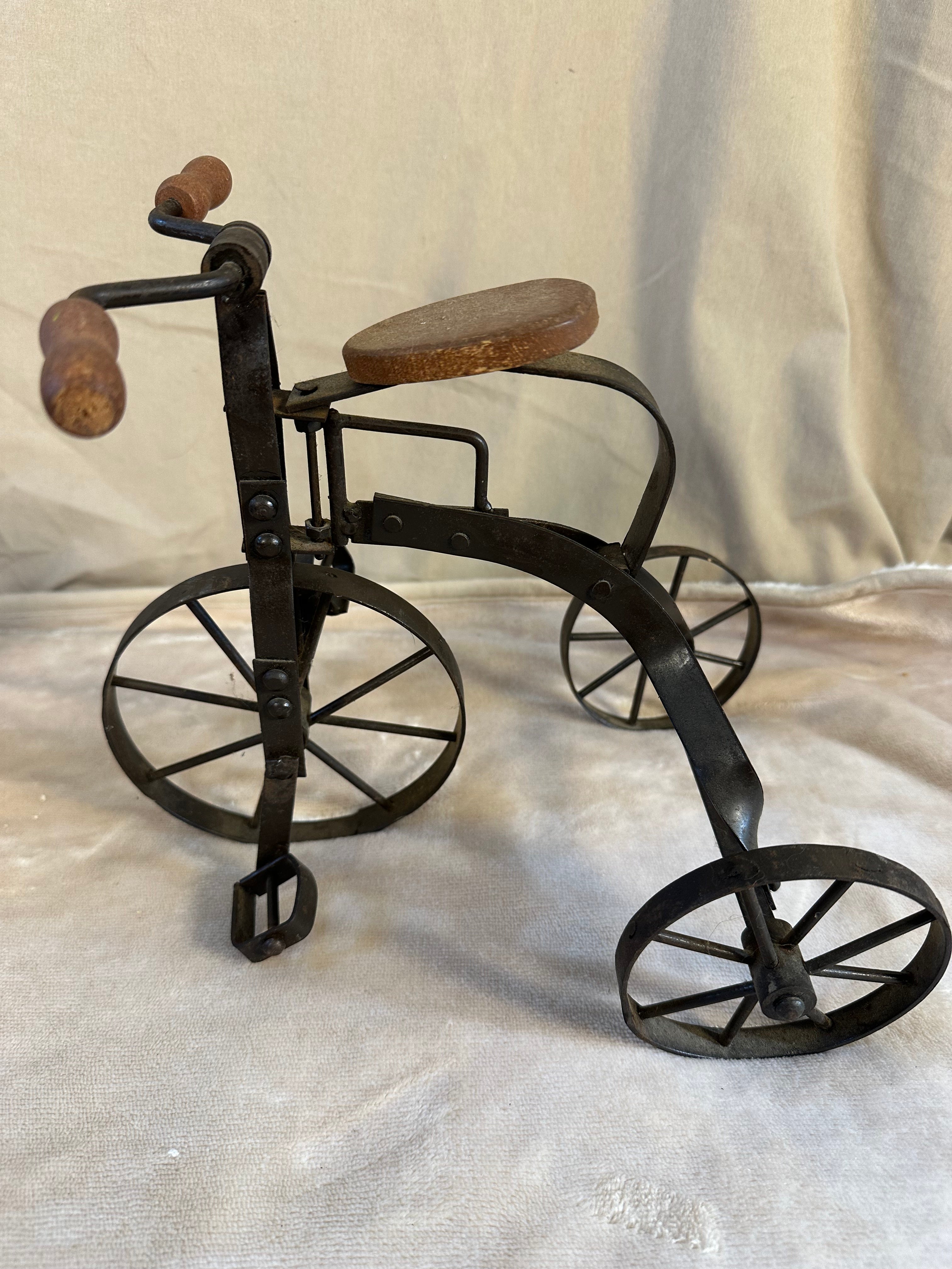 Decorative collectible metal tricycle with wooden seat and handles